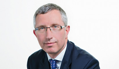 Jon Davies, man wearing glasses in blue suit